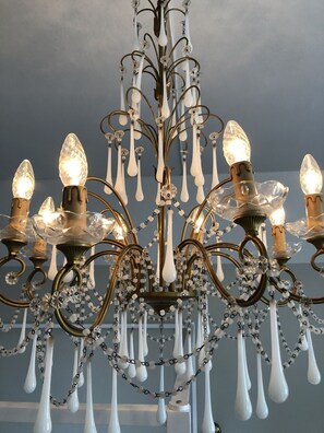 A chandelier with multiple light fixtures and decorative elements.