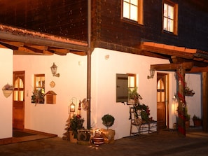 Experience the charm of a traditional European-style building with a welcoming entrance and rustic facade.