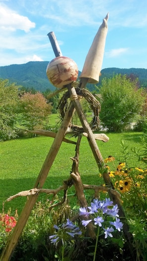 Surrounded by lush greenery, this charming garden feature offers a serene escape amidst a picturesque hilly landscape.