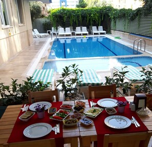 Outdoor pool, pool umbrellas, sun loungers