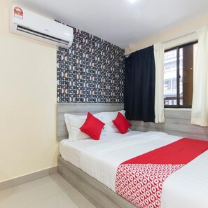 A hotel room with a bed, a patterned wall, an air conditioning unit, and a view of the outside. - Hotel KL Centre Point (Kuala Lumpur)