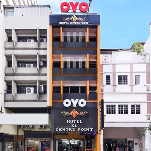 A hotel with a prominent 'OYO' sign, multiple balconies, and a modern facade. - Hotel KL Centre Point (Kuala Lumpur)