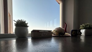 A wooden box labeled "Tea" on a windowsill, a potted plant, a straw hat, and a mug. - Lemon Factor Sorrento (Sorrento)