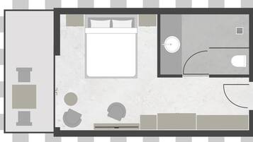 A hotel room layout with a bed, a small bathroom, a seating area, and a dining table.