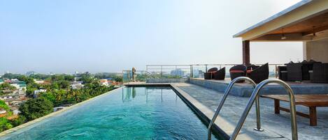 Outdoor pool, open 6 AM to 10:00 PM, pool umbrellas, lifeguards on site