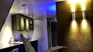 A modern bathroom with a vanity, mirror, and wall-mounted light fixtures. - Apart Food and Drinks (Zwolle)