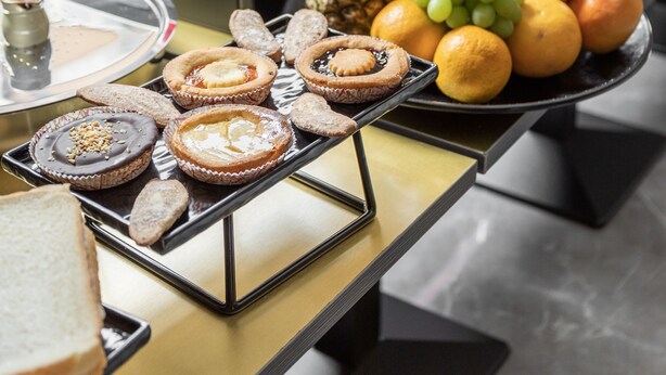 A buffet with various food items including pastries, fruits, and beverages. - Lake Como Golf Hotel (Carimate)