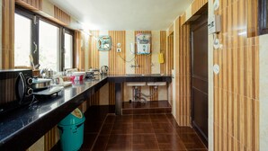 A modern kitchen with a black countertop, stainless steel appliances, and a window providing natural light.
