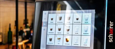 A digital menu display with various coffee and drink options.