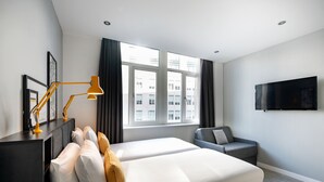 A modern hotel room with a large bed, a desk with a lamp, a sofa, and a TV mounted on the wall. - Staycity Aparthotels, Liverpool, Waterfront (Liverpool)
