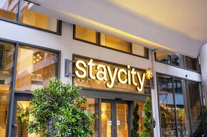 A building with a sign reading "Staycity" and "apart-hotels".