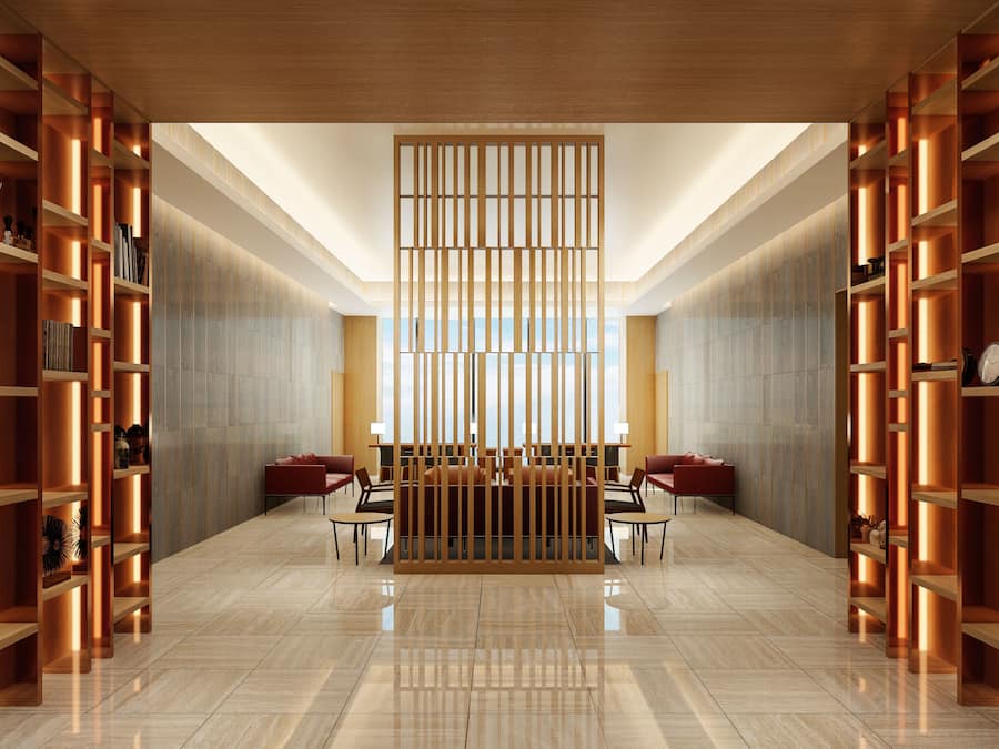 A spacious lobby with a central seating area, high ceilings, and a view through a large window.