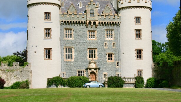 A castle-like building with multiple towers and a central entrance. - Hamilton House Holiday Apartments (Downpatrick)
