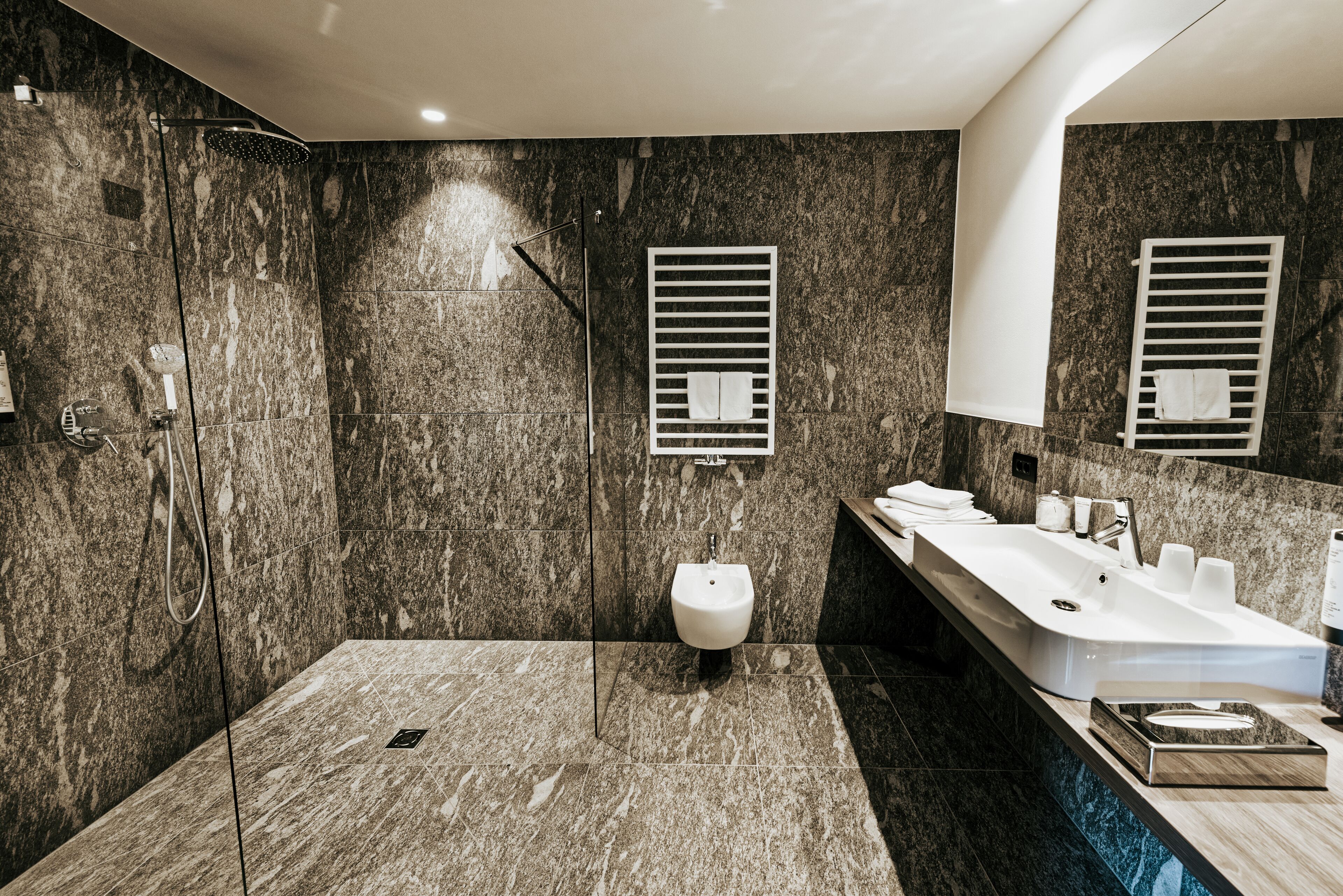 premium suite | bathroom | designer toiletries, hair dryer, bathrobes, slippers