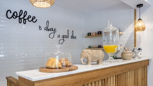 A coffee station with a sign saying "Coffee is always a good idea," a glass container with orange juice, and a basket shaped like an elephant. - The Poyz Hotel Bodrum (Bodrum)