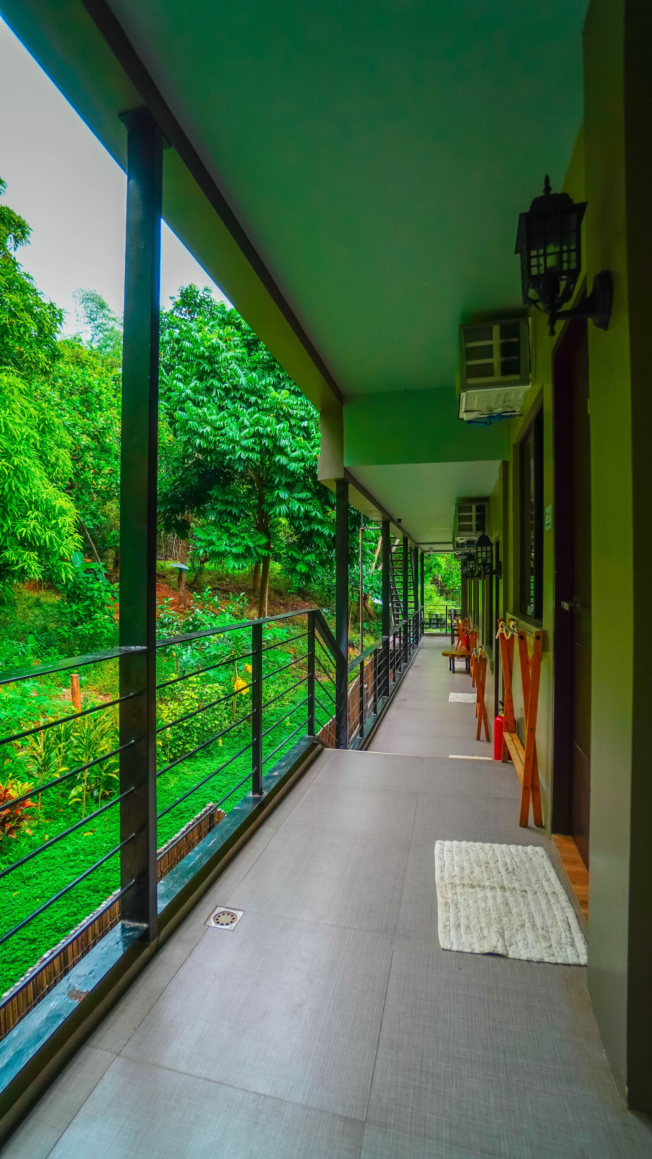 A covered walkway with a view of lush greenery.
