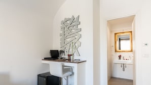 A modern bathroom with a white sink, mirror, and marble flooring. - Le suites del duomo house (Catania)