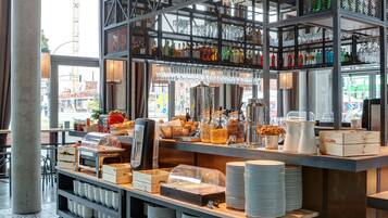 A buffet setup with various food items and beverages.
