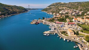 A coastal town with a marina, a bridge in the distance, and buildings with red roofs. - Hedera Estate, Villa Hedera X (Mokosica)