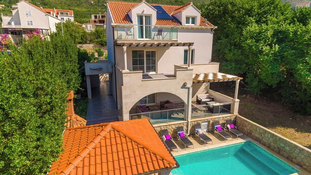 A modern villa with a swimming pool, a covered patio, and a view of the surrounding hills. - Hedera Estate, Villa Hedera X (Mokosica)