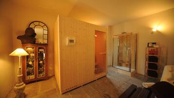 Traditional room with a wardrobe, cabinet, and shelf, featuring a glass-enclosed shower area.