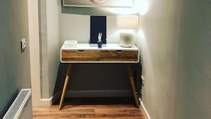 A modern bathroom with a vanity, mirror, and two wall-mounted lights. - The Lane Apartment (Edinburgh)
