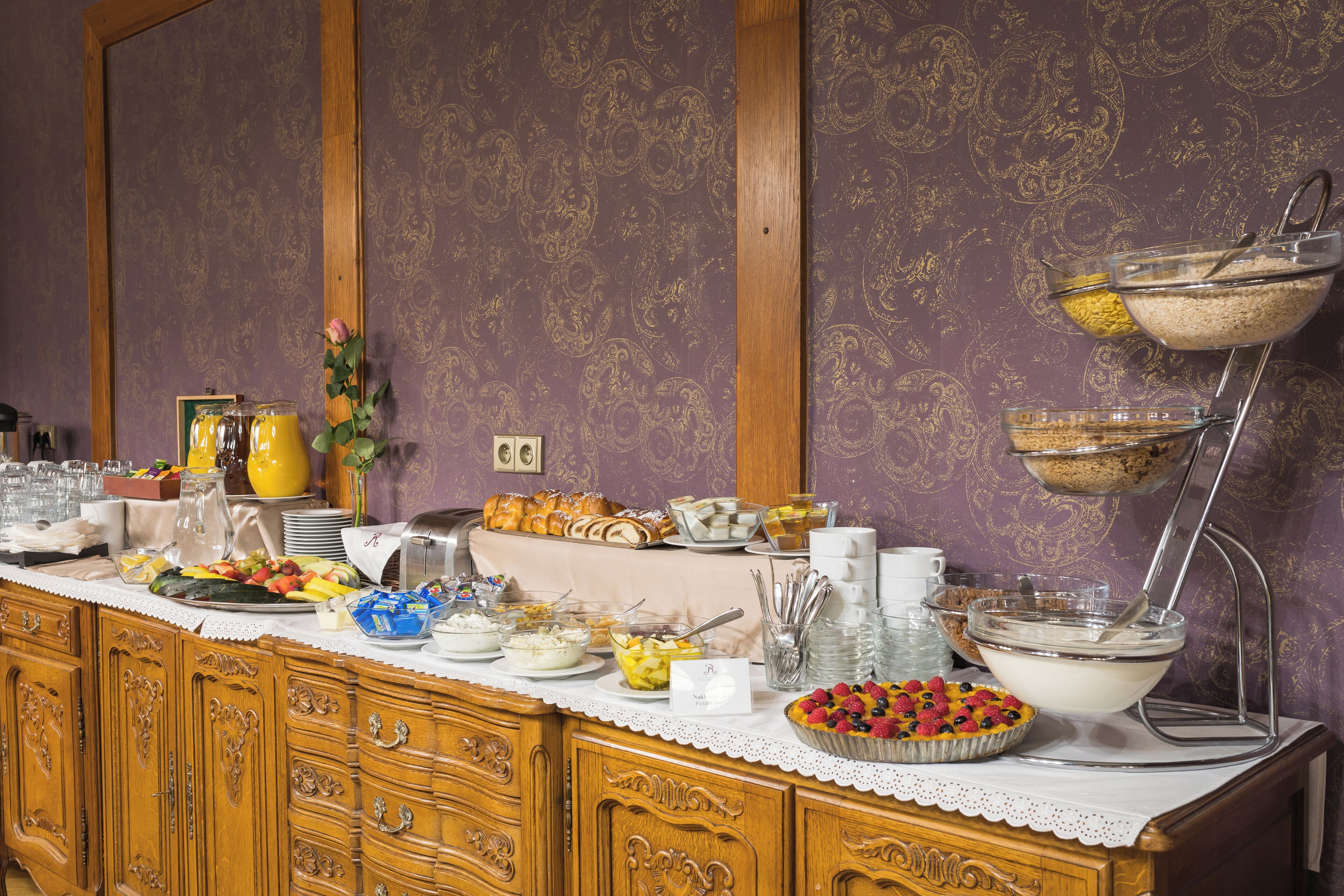 A buffet setup with various food items and a coffee station.