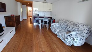 A compact living space with a kitchenette, a dining area, and a sofa. - Comfortable apartment in Montgenèvre with balcony and parking (Montgenèvre)