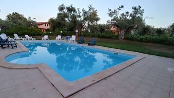 Seasonal outdoor pool, open 9:00 AM to 7:30 PM, pool umbrellas