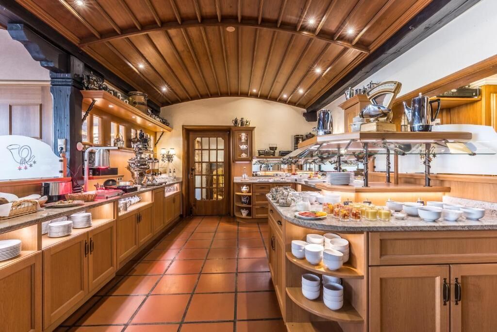 A kitchen with wooden cabinets, a central island, and various kitchen appliances.