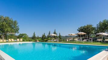 Alberca al aire libre por temporada y sombrillas en la alberca