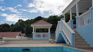 A swimming pool with a gazebo and a staircase leading to a covered area. - Trilogy Villas (Falmouth Harbour)