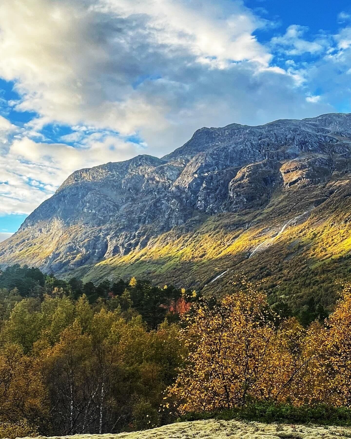 A mountainous landscape with a winding road.