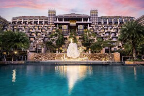A modern hotel with a central fountain, a pool, and a multi-story building with balconies. - The Apurva Kempinski Bali (Nusa Dua)