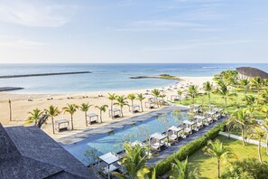 A resort with a pool, beach, and ocean view.