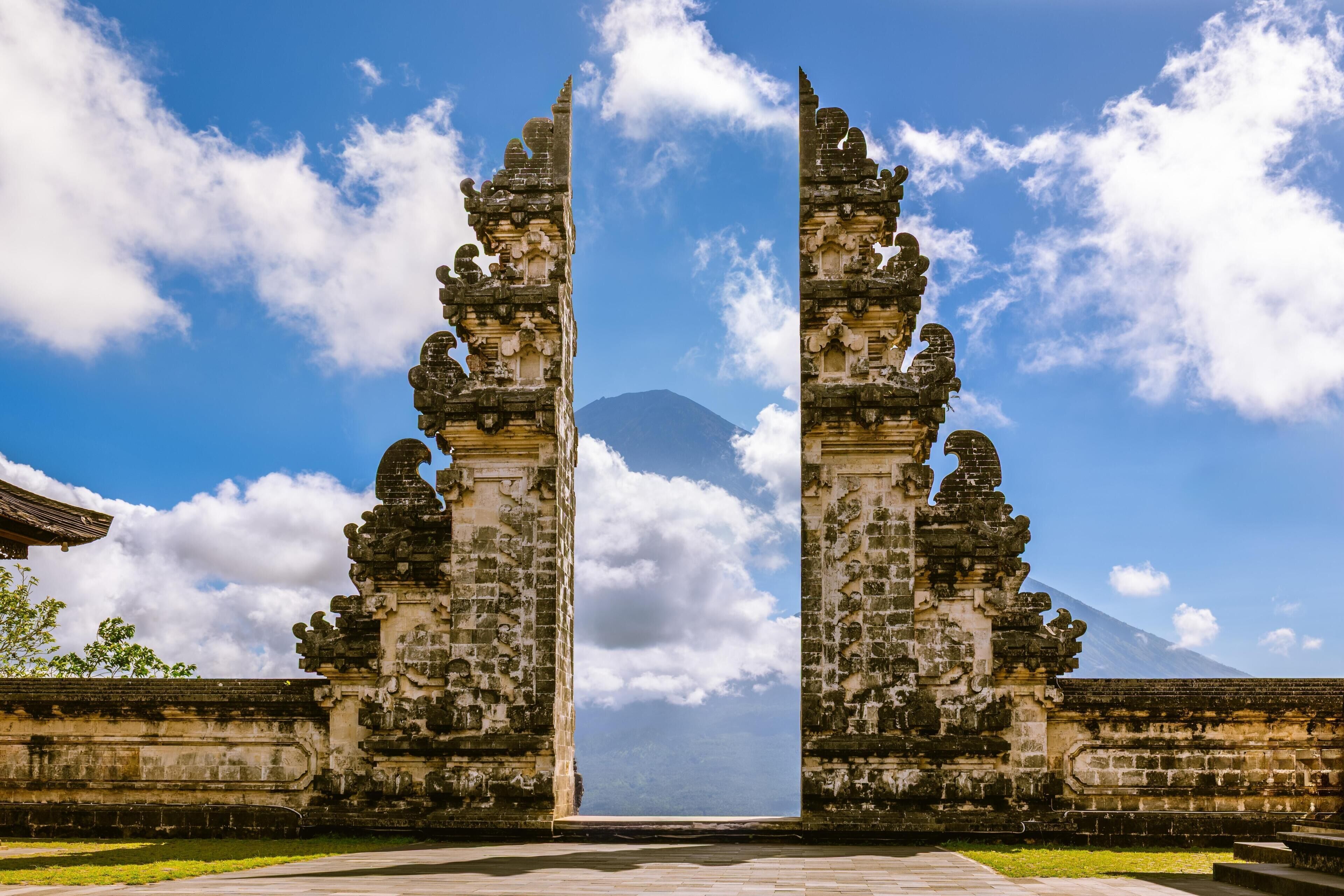 A temple entrance with a clear sky and distant mountain.
