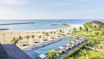 A resort with a pool, beach, and ocean view.
