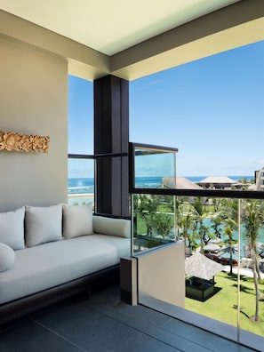 A modern room with a large window overlooking a pool and ocean. - The Apurva Kempinski Bali (Nusa Dua)