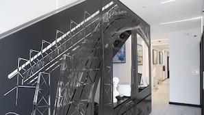 A modern interior with a staircase featuring a geometric metal design.