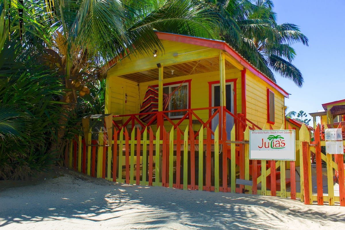 A colorful wooden building with a sign that reads "Jutias."