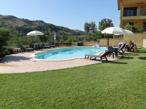 Outdoor pool, open 8 AM to 7 PM, pool umbrellas, pool loungers