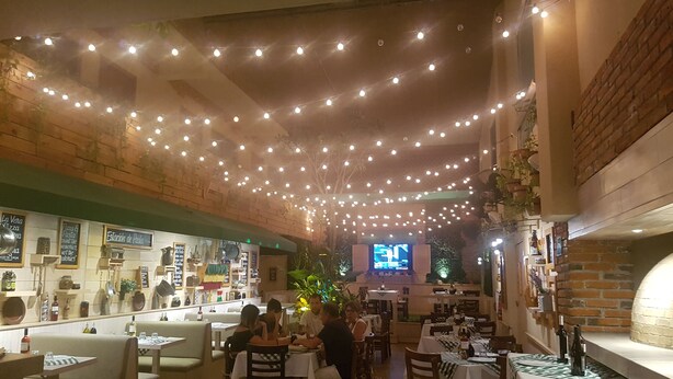 An indoor dining area with string lights, tables, and chairs. - Suites Calle 8 (Playa del Carmen)