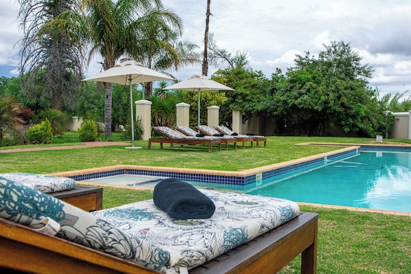 Outdoor pool, pool umbrellas, sun loungers