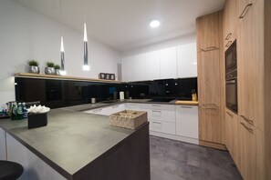 Luxury Apartment, Multiple Beds, Non Smoking | Private kitchen | Full-size fridge, stovetop, dishwasher, electric kettle