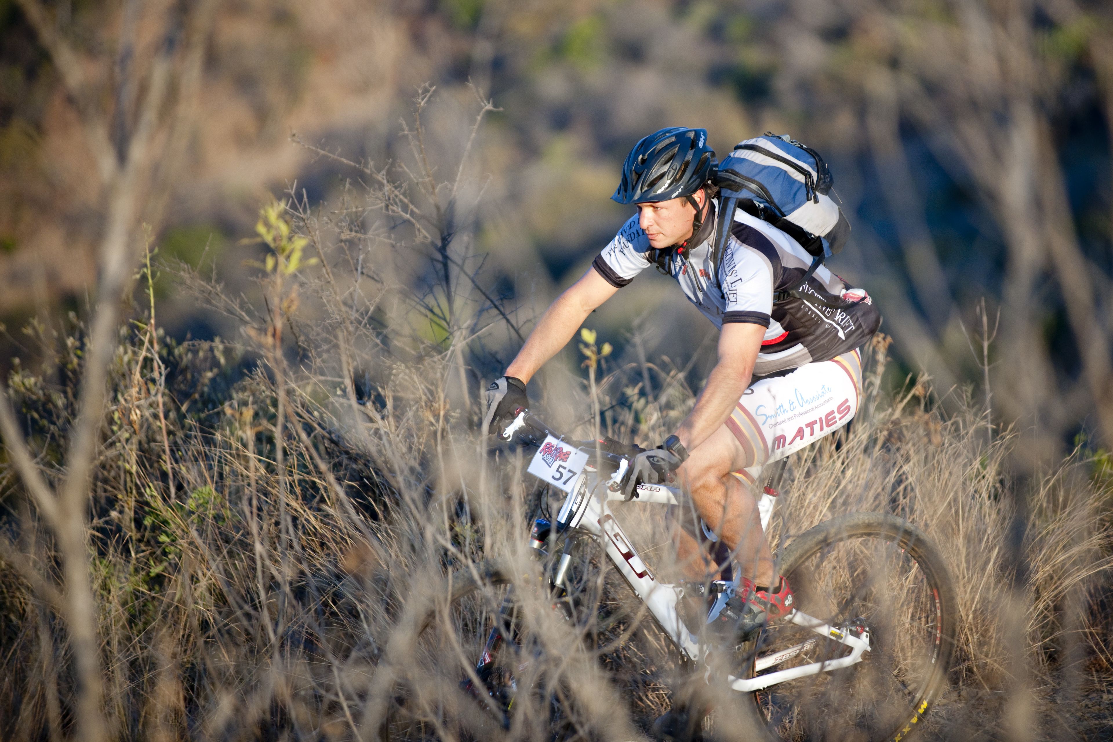 A mountain biker navigating through a field.
