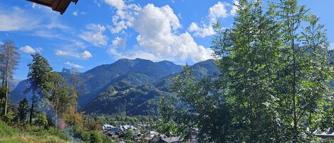 A mountain landscape with a village and houses in the valley.