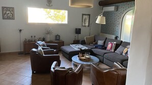 Ein Wohnzimmer mit einer Sofagarnitur, einem Couchtisch und einer Lampe.
