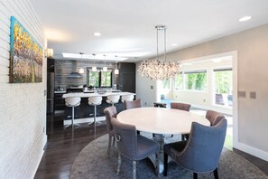 Enjoy meals at the central island with a stove and ample counter space, surrounded by cabinetry.