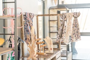 A jewelry display with various necklaces and bracelets on wooden stands.