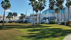A modern building with a sign reading "Texas State Aquarium." - 1st FLOOR LARGE 1BR, BEAUTIFUL Beach Getaway!  Pool, Hot Tub, Sauna & More (Corpus Christi)